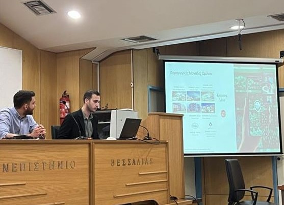Marios Vassileiou delivers his presentation. Marios Vassileiou delivers his presentation. A big screen where slides are projected is visible on the right hand side